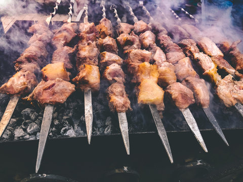 Mcvadi - shashlik preparing on a barbecue grill over charcoal. Roasted stacked meat traditional cuisine in Georgia