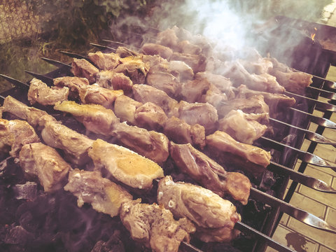 Mcvadi - shashlik preparing on a barbecue grill over charcoal. Roasted stacked meat traditional cuisine in Georgia