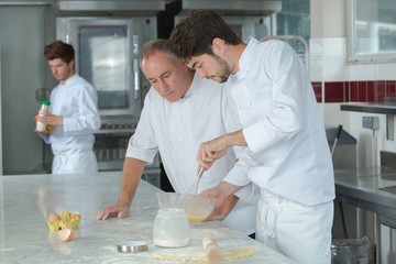 apprentice chef preparing food in the kitchen at the restaurant