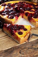 cherry cake and a bunch of cherries on table