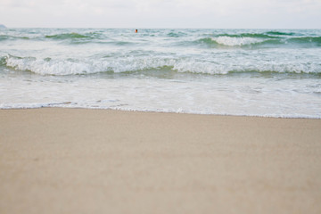 The sea waves on the beach in the morning, the sun is not soft focus