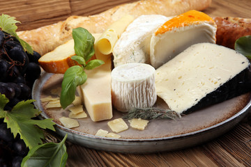 Cheese platter with different cheese on rustic plate