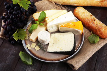 Cheese platter with different cheese on rustic plate