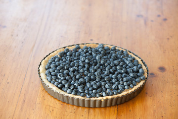 Fototapeta na wymiar Blueberry Tarte / Blueberry Pie on a wooden table