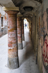 Fototapeta na wymiar Venice, Italy - Jine, 28, 2018: columns on a pedestrian street in a center of Venice, Italy