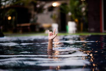 Love hand in the pool. Give it to a loved one. Located on the water side of the pool.