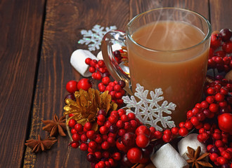 Hot chocolate with marshmallows and cinnamon . christmas decorations on a  old wooden background. Christmas background.