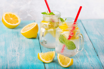 citrus fresh lemonade soda ice mint lemon wooden background
