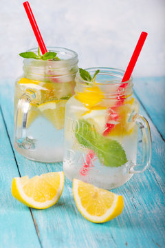 citrus fresh lemonade soda ice mint lemon wooden background
