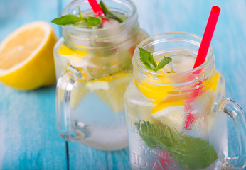 citrus fresh lemonade soda ice mint lemon wooden background
