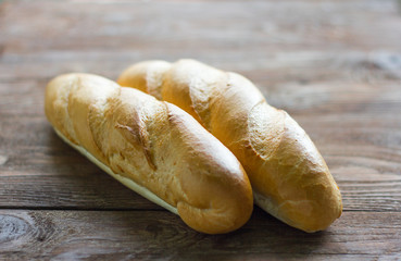 fresh baguettes close-up on wooden background