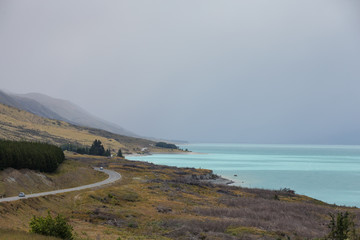 The road next to Lake Pukaki with it's beautiful turquoise waters, south island, New Zealand