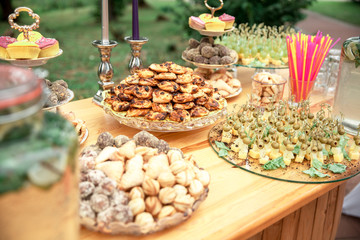 Candy bar and wedding cake. Table with sweets, buffet with cupcakes, candies, dessert.