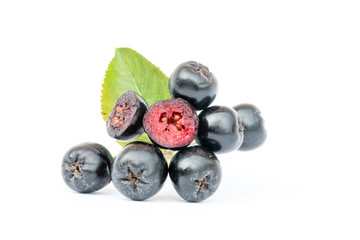 Ripe Chokeberry or Aronia melanocarpa with leaf isolated on white background. Organic and vegetarian food full of vitamin and antioxidant. Cross section.
