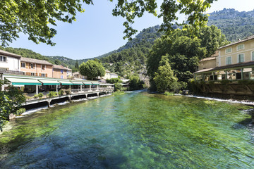 Fototapeta na wymiar Restaurants on the Sorgue in Fontaine de Vaucluse. Vaucluse, Provence, France, Europe