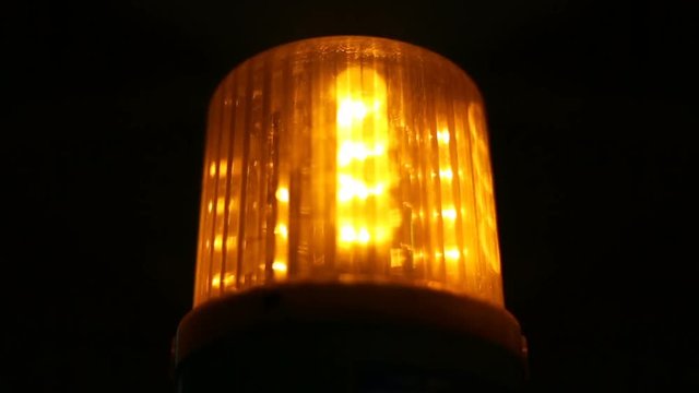 Close-up of soft focused spinning amber flasher, Warning hazard sign