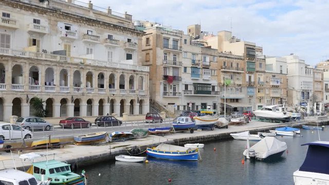 Malta embankment and beautiful buildings and boats view from moving ferryboat