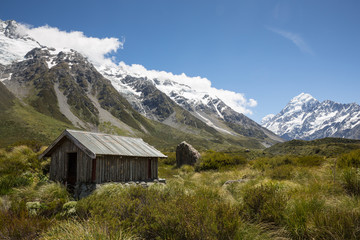 Fototapeta na wymiar Hut in Aoraki Mount Cook national park, south island, New Zealand. Mount Cook visible in the distance