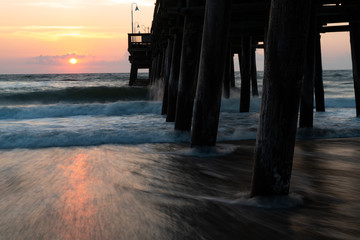 The waves splash along the Sandbridge Fishing Pier in Sandbridge Virginia, Virginia Beach during a...