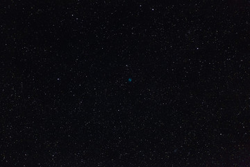 The Dumbbell Nebula and the stars of outer space in the night sky. Photographed on a long exposure.