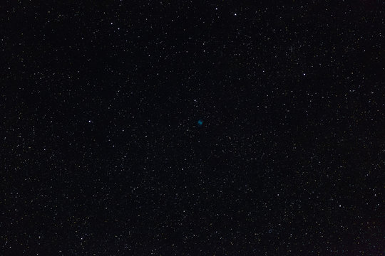 The Dumbbell Nebula and the stars of outer space in the night sky. Photographed on a long exposure.
