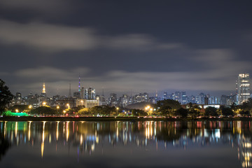 Fototapeta na wymiar Sao Paulo, Brazil. June 02, 2017: Night view lake in Ibirapuera Park and Sky line of city in Sao Paulo.