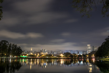 Naklejka premium Sao Paulo, Brazil. June 02, 2017: Night view lake in Ibirapuera Park and Sky line of city in Sao Paulo.