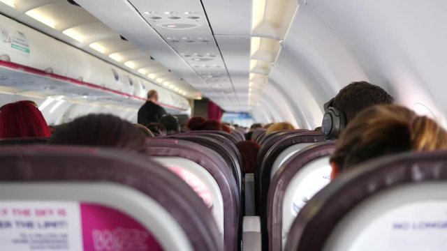 During plane flight people on their sits - passenger cabin of the aircraft