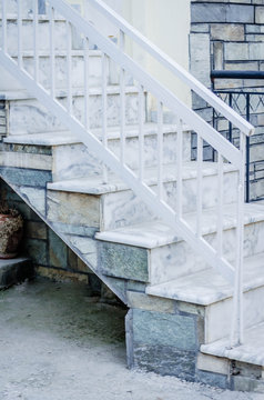 staircase of white marble in front of the house