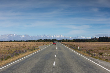 Fototapeta na wymiar Traffic on the Fairlie Tekapo road near lake Tekapo, south island New Zealand