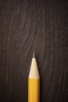 Overhead view of pencil on wooden table