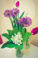 bouquet of wild flowers in a glass with blurred background