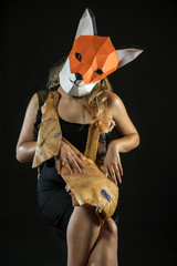 Blonde Girl in Black Evening Office Dress with Fox Mask paper Using Pig Skin for Covering.