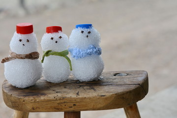 Little snowmen in a group carol singing in the snow