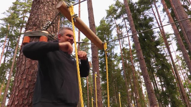 Man on zip line in forest