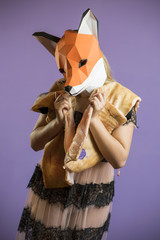 Blonde Girl in Seethrow Dress with Fox Mask paper Using Pig Skin for Covering. Dead Animal Consuming