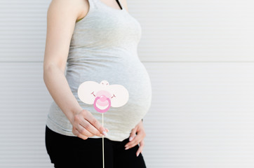 Portrait of pregnant woman with cute prop