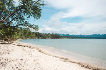 Costa Rica Caribbean beach off Cahuita National Park coastline with jungle and mountains in view