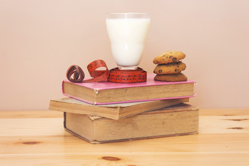 lose weight concept, milk cup and cookies with book  
