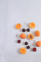 Apricots and cherries isolated on white backgroud Summer fruit and berries concept Harvesting Organic fruits Copy space