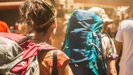 Happy young woman with backpacks enjoying the trip