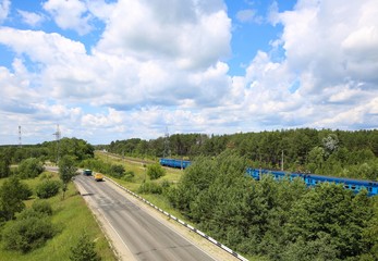 Panorama with passenger train and cars.