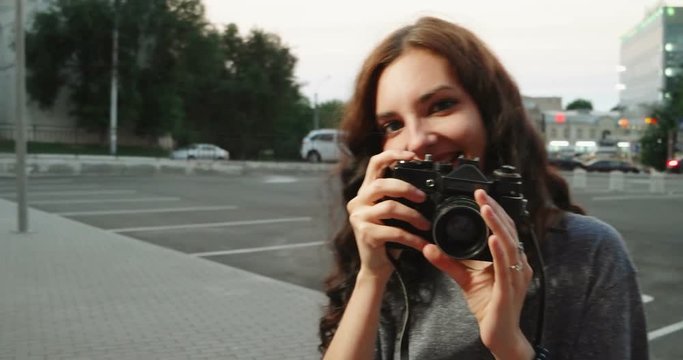 Girl taking photo with film camera