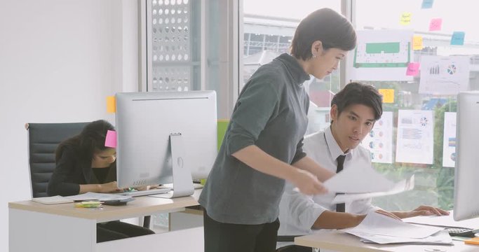Young asian businessman gets paper with good news from executive, appreciating for good job, employee recognition.