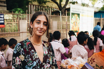 Woman standing near a group of students
