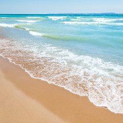 Beach With Blue Water And Sand