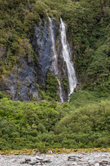 Fototapeta premium Waterfall and vegetation at Franz Josef Glacier, south island New Zealand