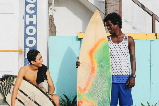 Two young men with surfboards