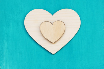 Naklejka na ściany i meble two wooden hearts on paint background