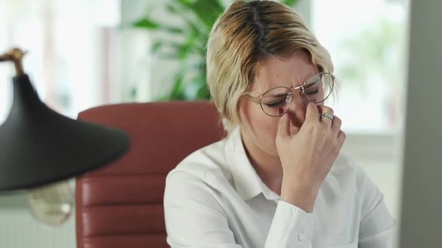 Stressed, Frustrated, Upset, Tense Business woman with Headache in Office